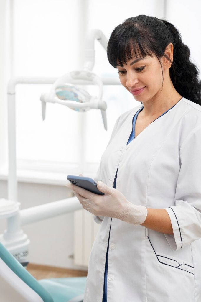 Canadian dentist checking responsive dental website design on mobile phone